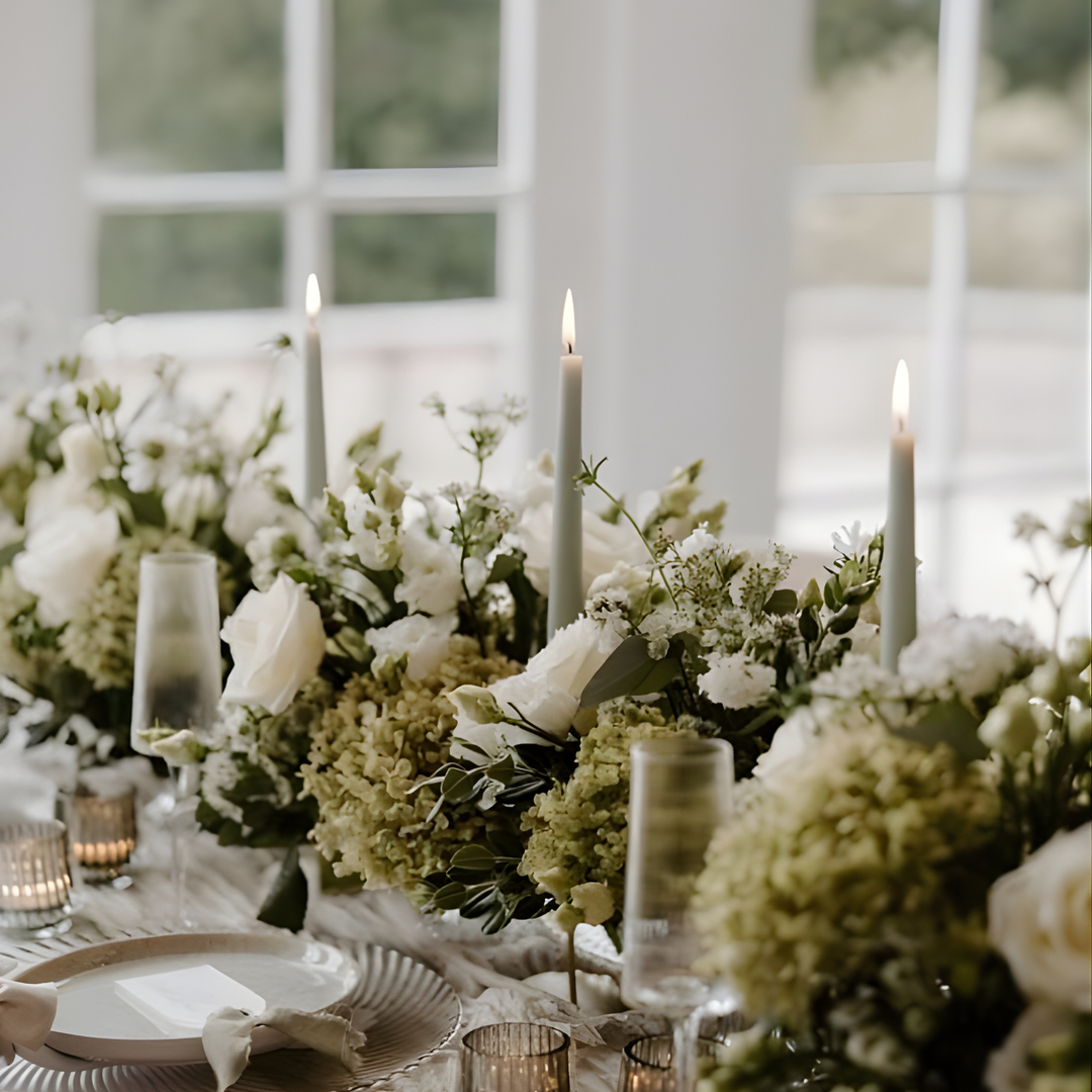 Moss Green taper candles styled on a wedding table, creating an elegant and natural centrepiece