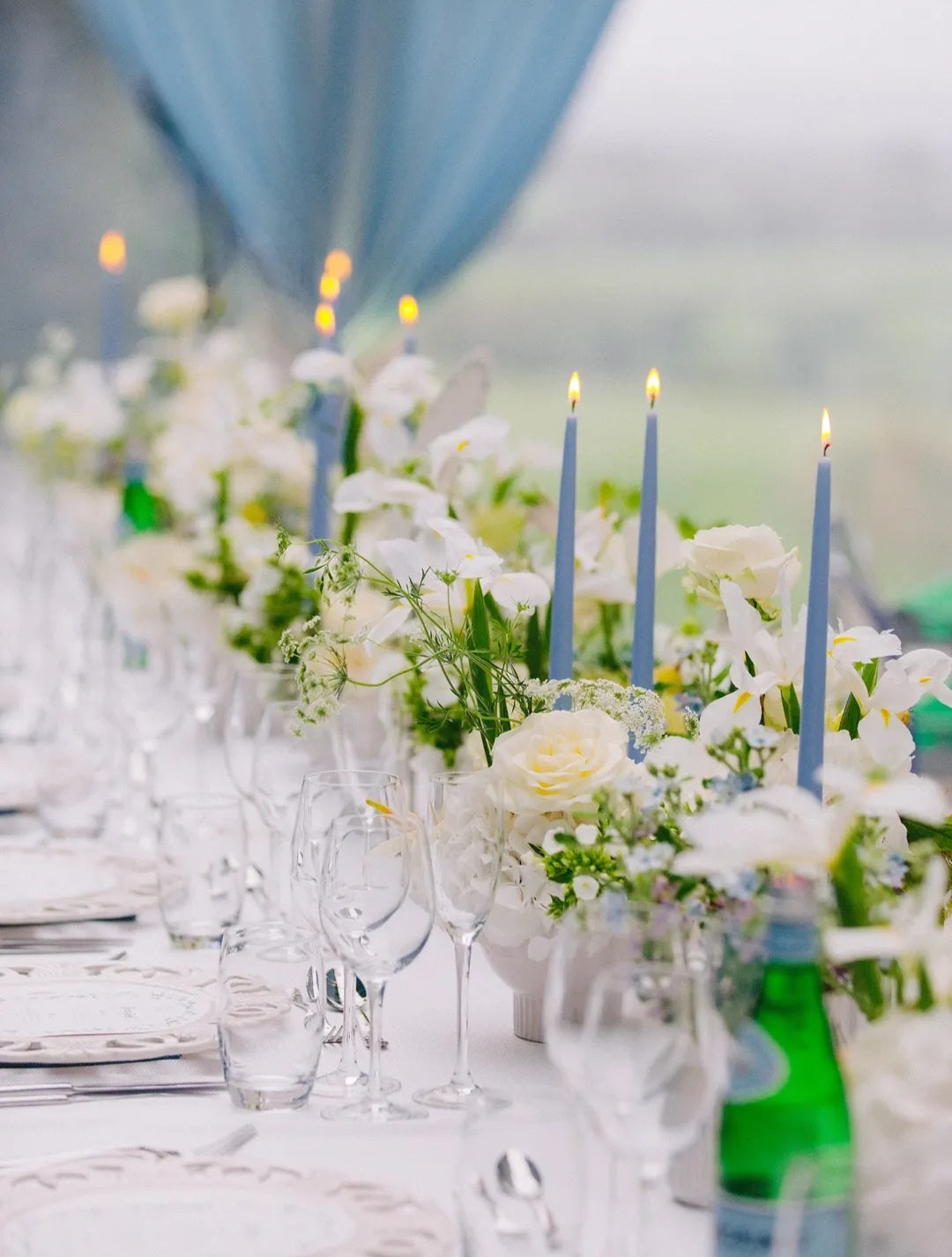 Elegant wedding tablescape with luxury taper candles creating a romantic candlelit atmosphere