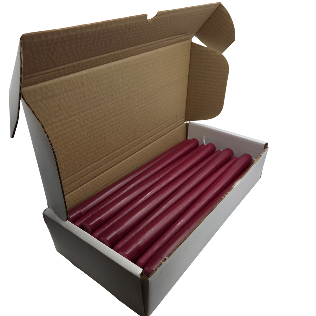 Box of Burgundy Red taper candles on a white background