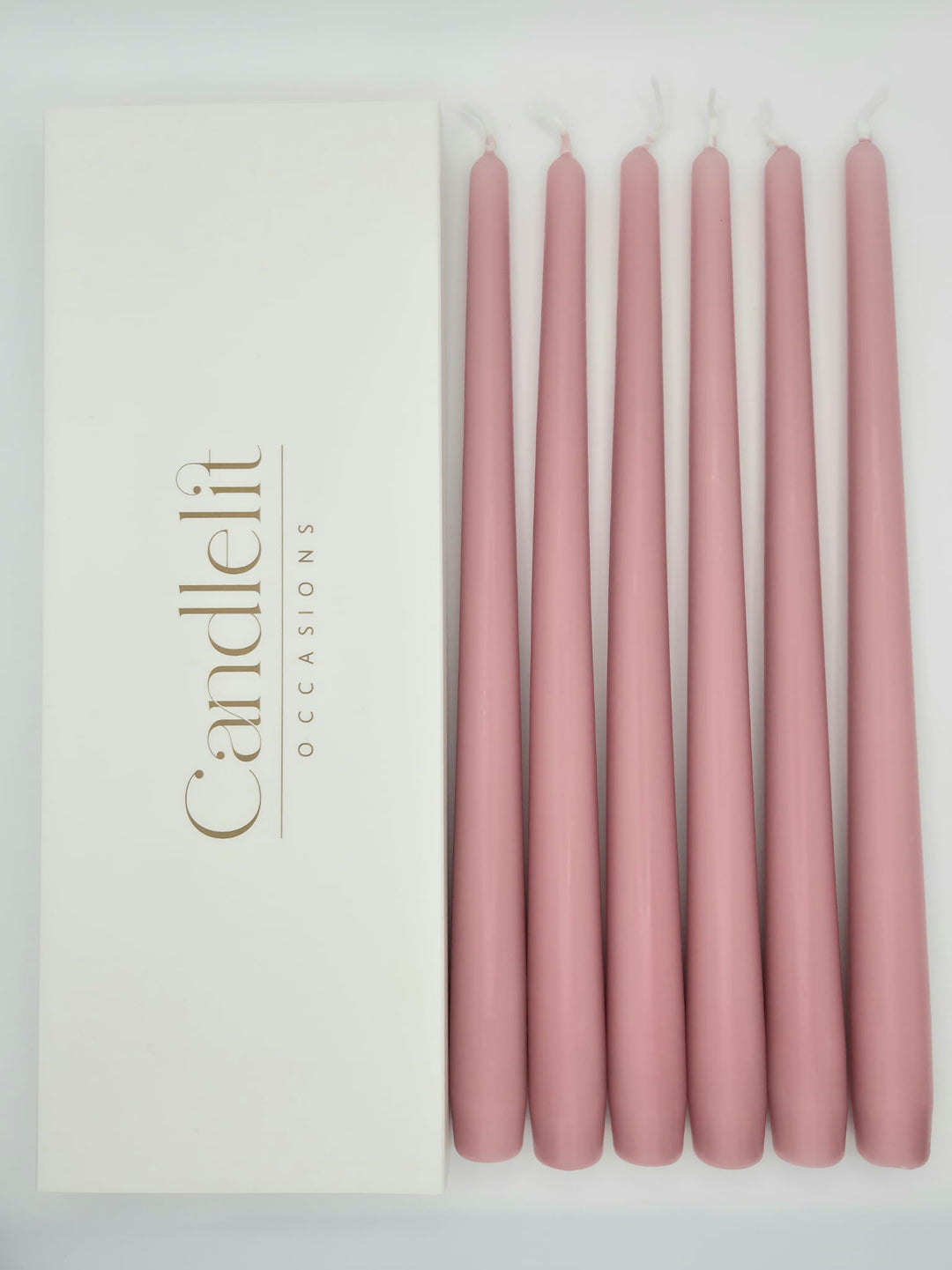 Dusty rose pink taper candles styled for luxury wedding tablescape