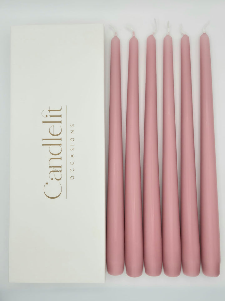 Dusty rose pink taper candles styled for luxury wedding tablescape