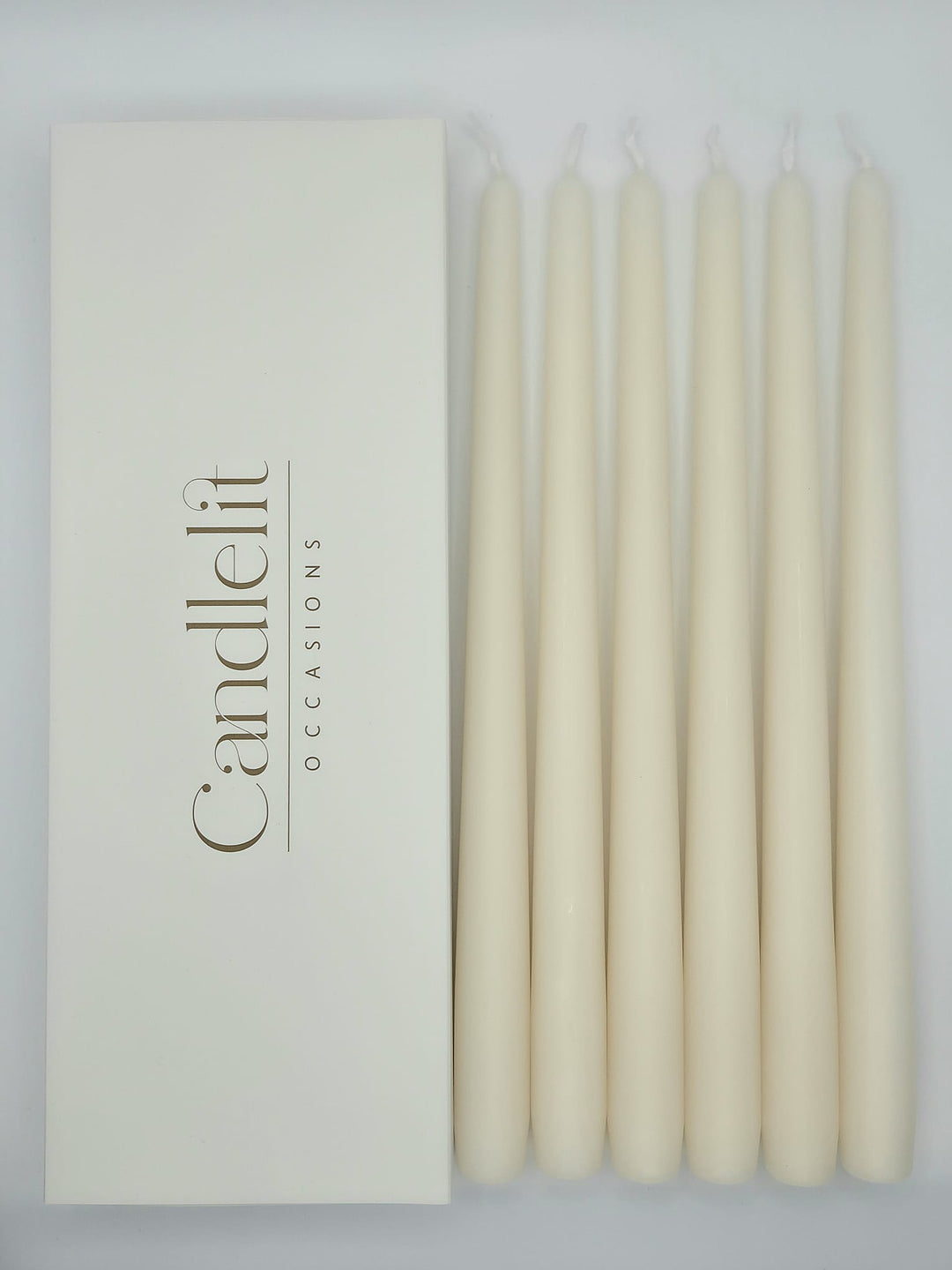Ivory taper candles styled for luxury wedding tablescape