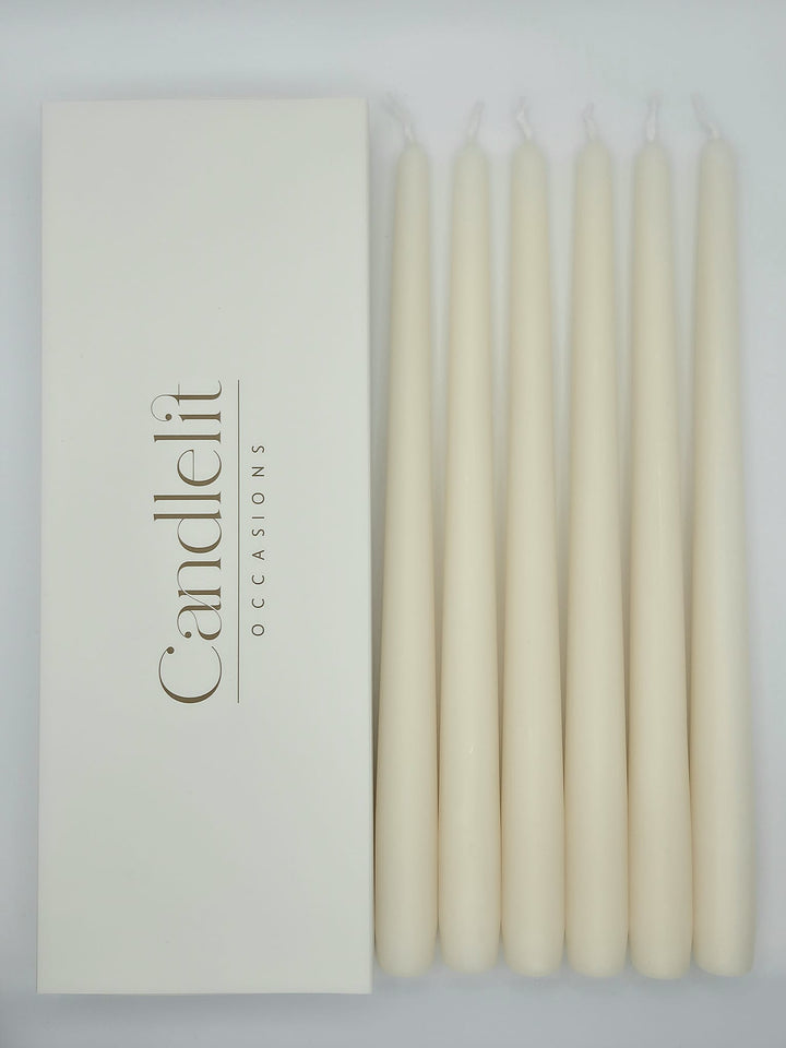 Ivory taper candles styled for luxury wedding tablescape