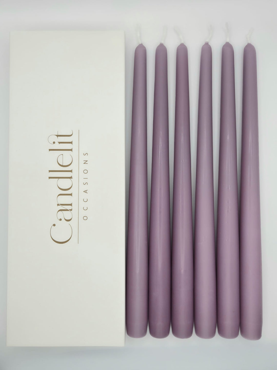 Lilac taper candles styled for luxury wedding tablescape