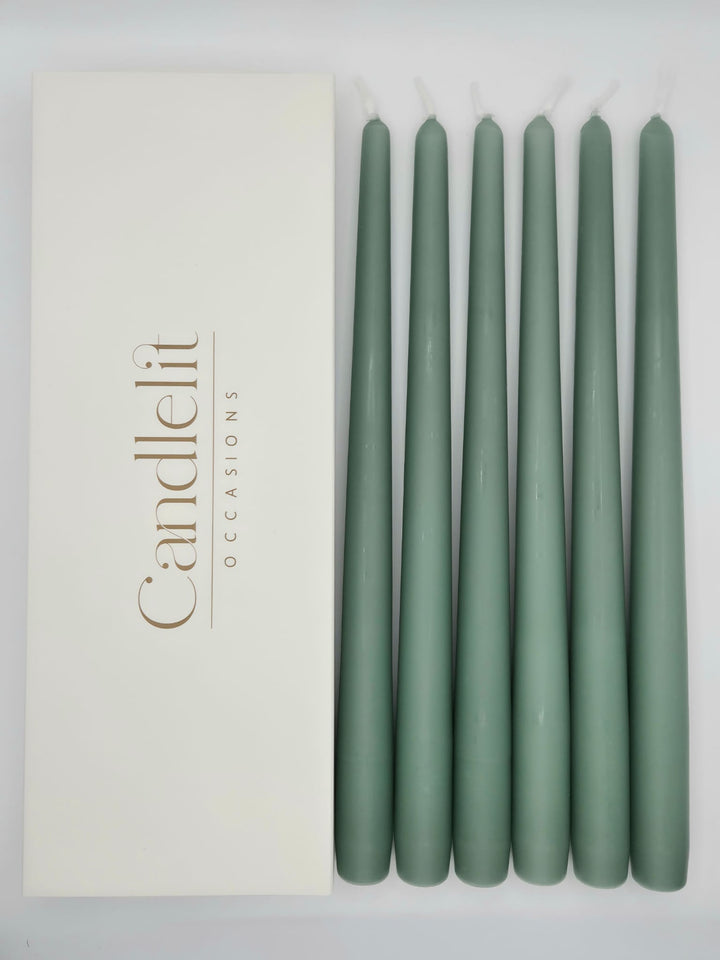Moss green taper candles styled for luxury wedding tablescape