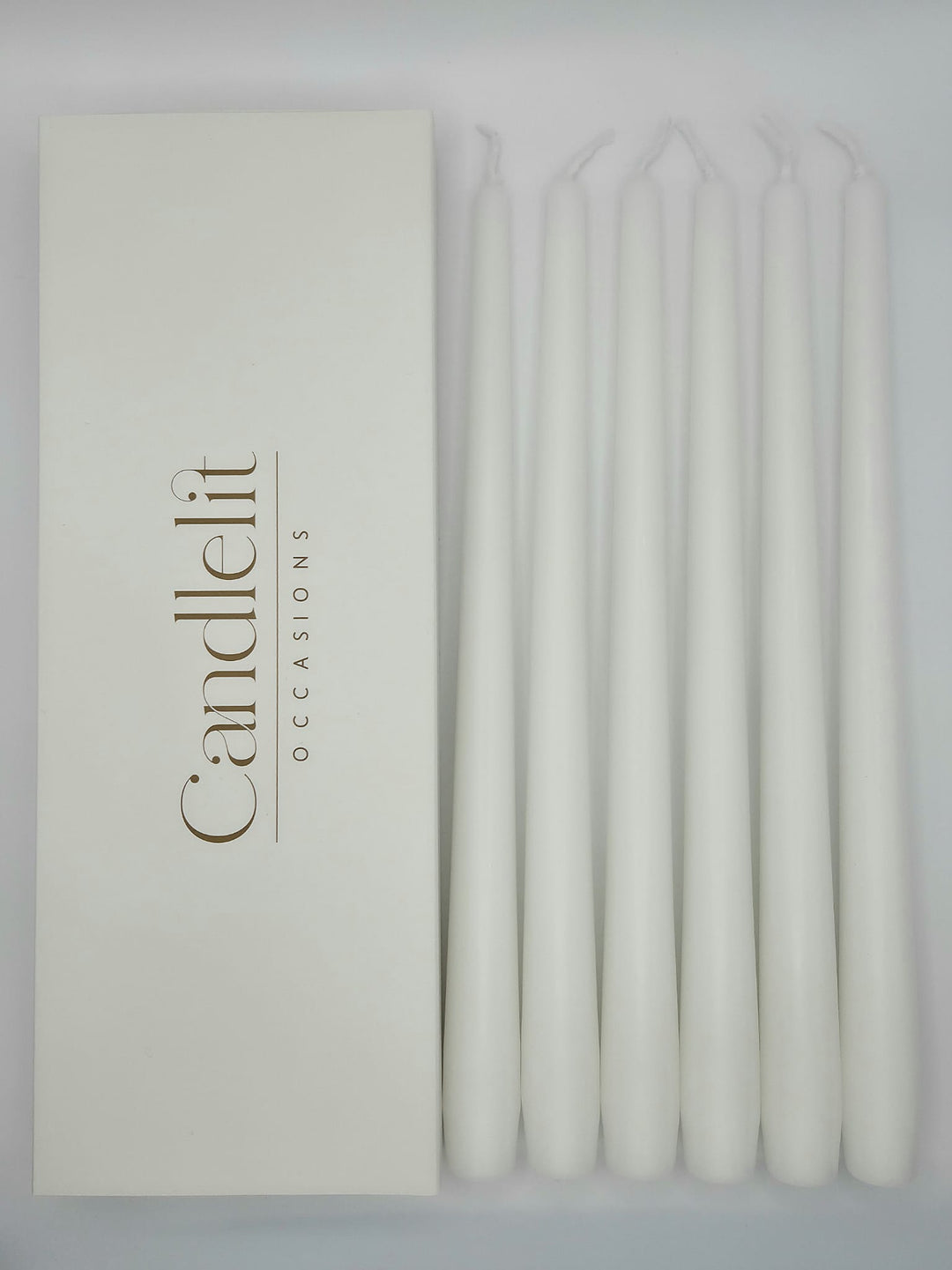 White taper candles styled for luxury wedding tablescape