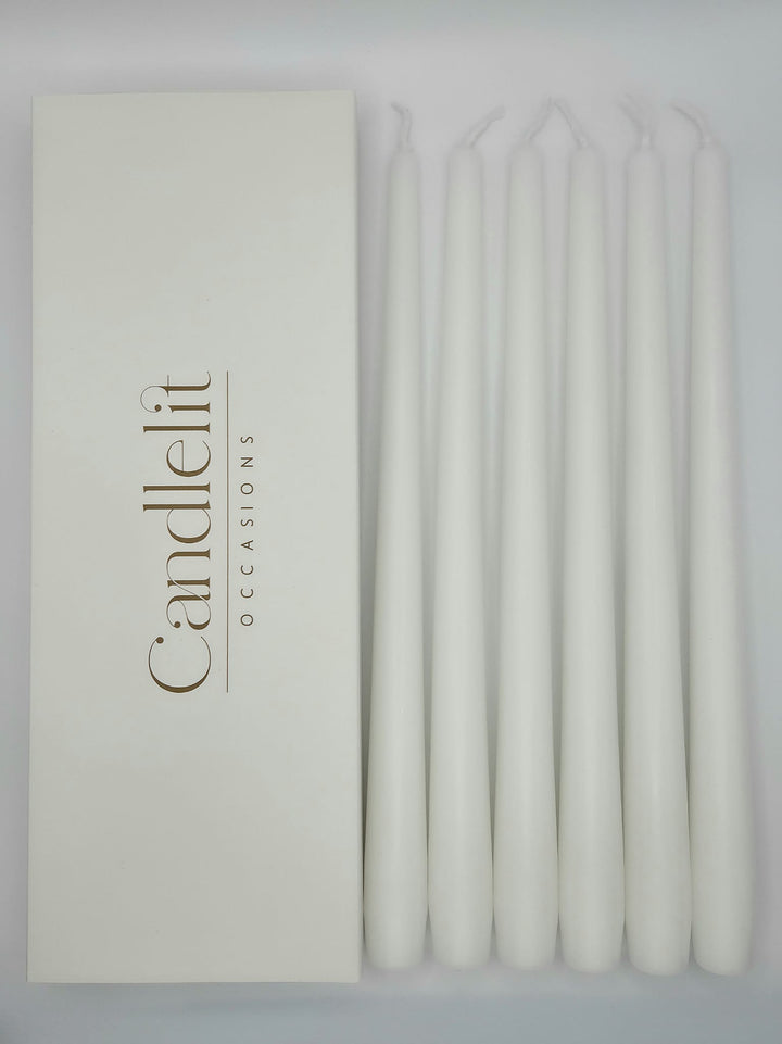 White taper candles styled for luxury wedding tablescape